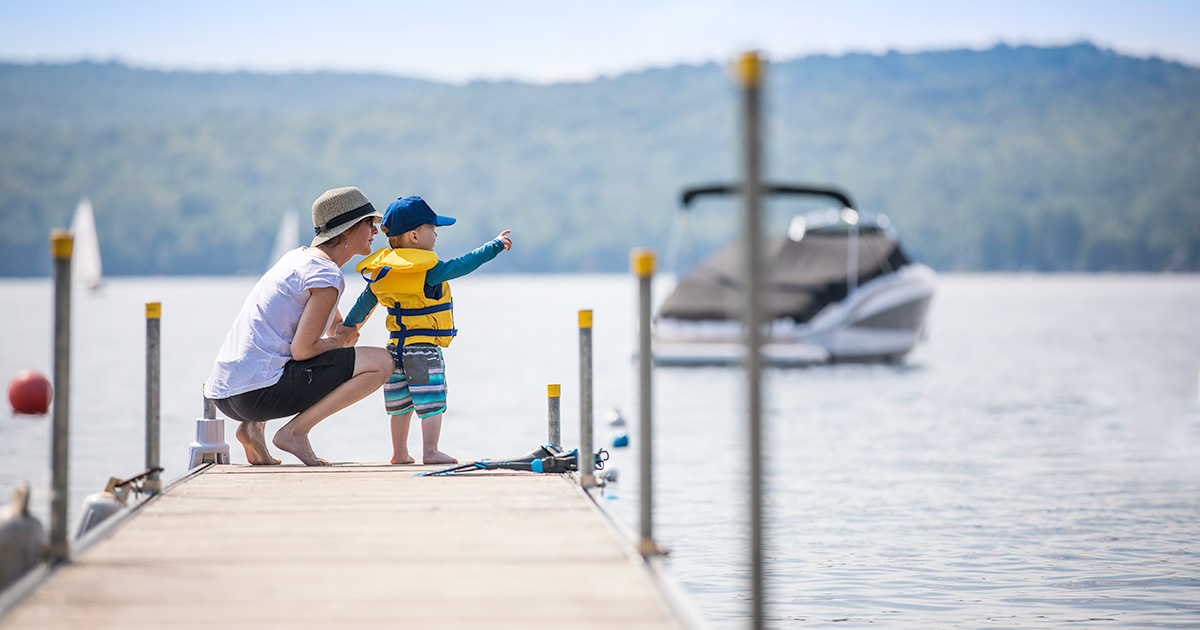Mother and toddler on a dock in the summertime