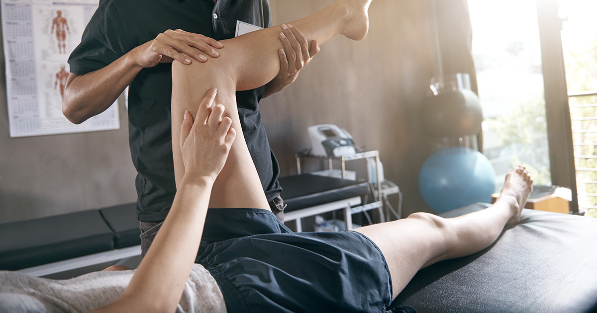 Physiotherapist helping a patient with a knee problem