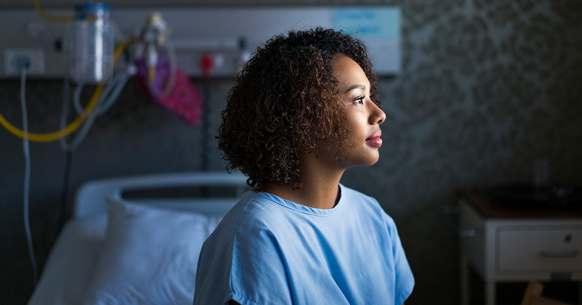 Female hospital patient looking out a window