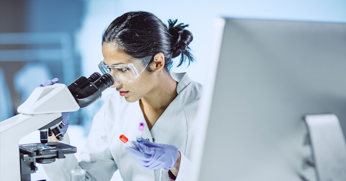Female scientist working with a microscope 2