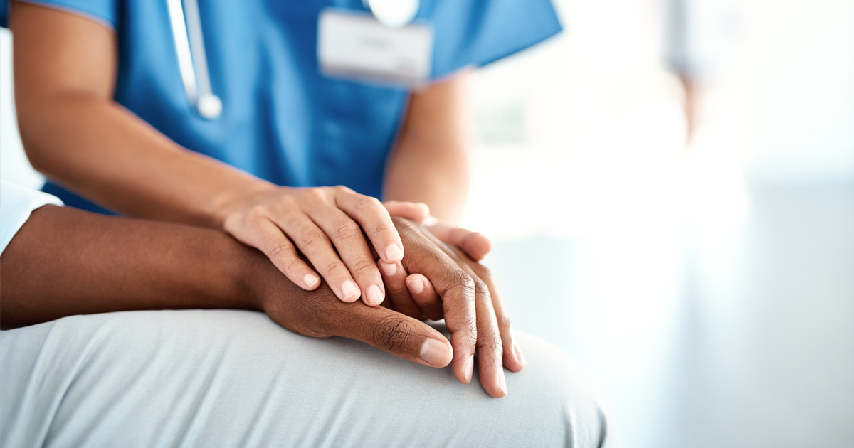 Nurse holding patient's hand