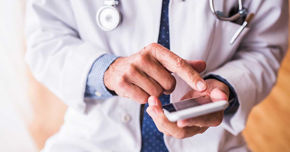 Close-up of doctor using a mobile phone