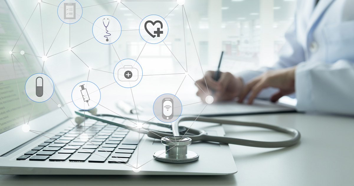 Health care icons over a doctor working with a computer