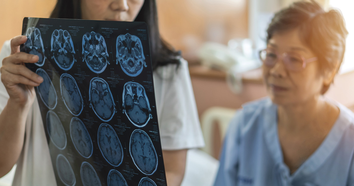 Neurologist showing woman scans of her brain