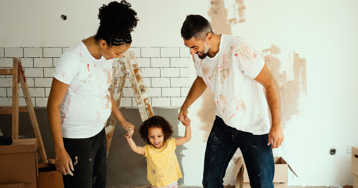 Parents and their young daughter in a room under renovation