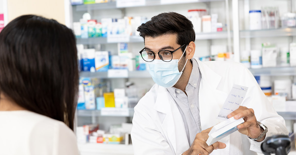 man pharmacist prescribing medication