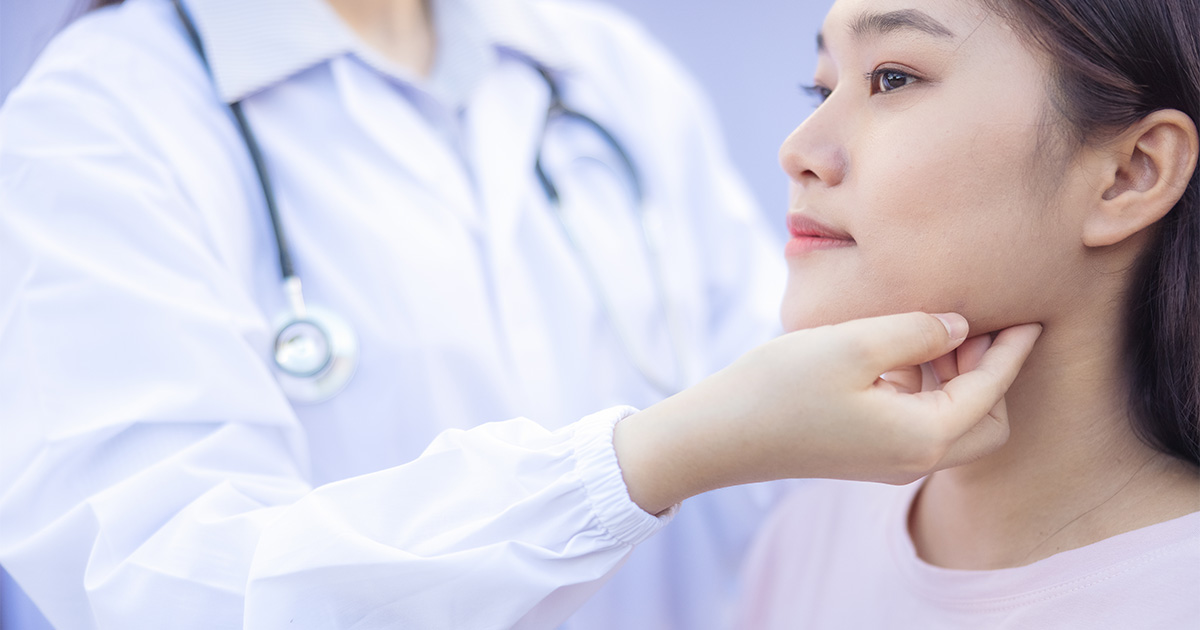 asian woman getting dental exam