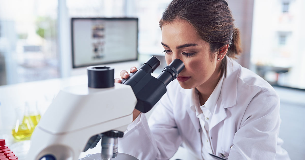 female scientist in lab microscope