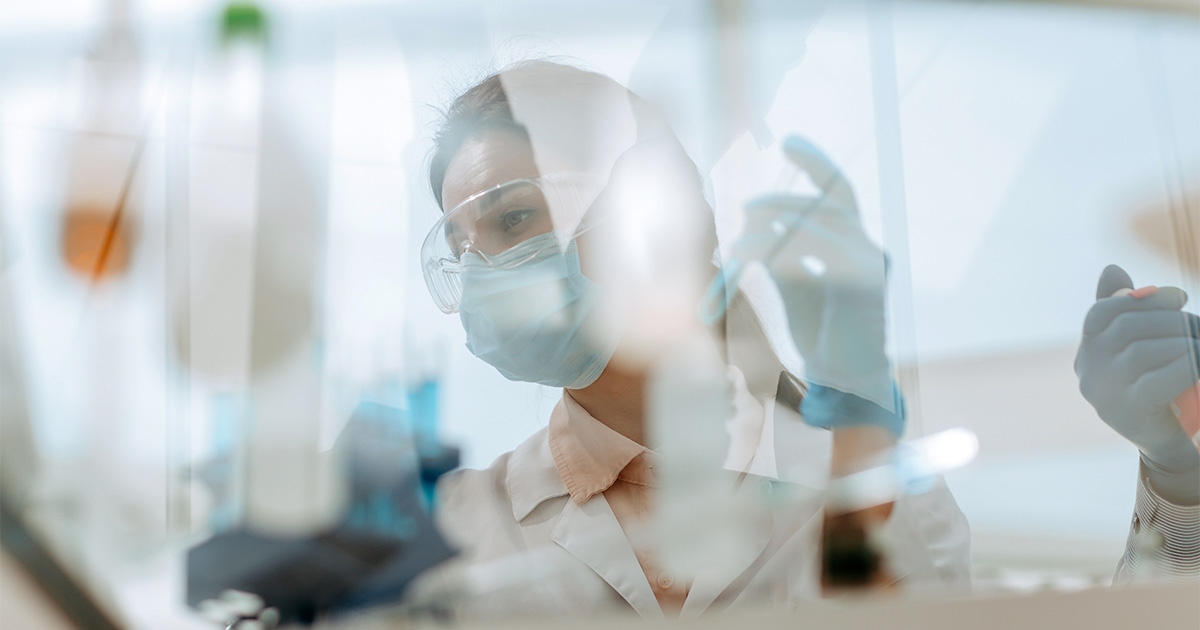 researcher in lab with mask
