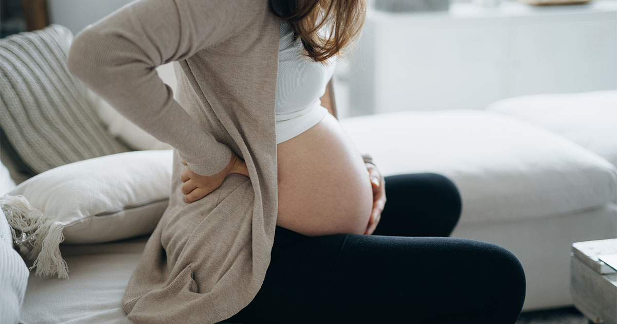 pregnant woman holding stomach
