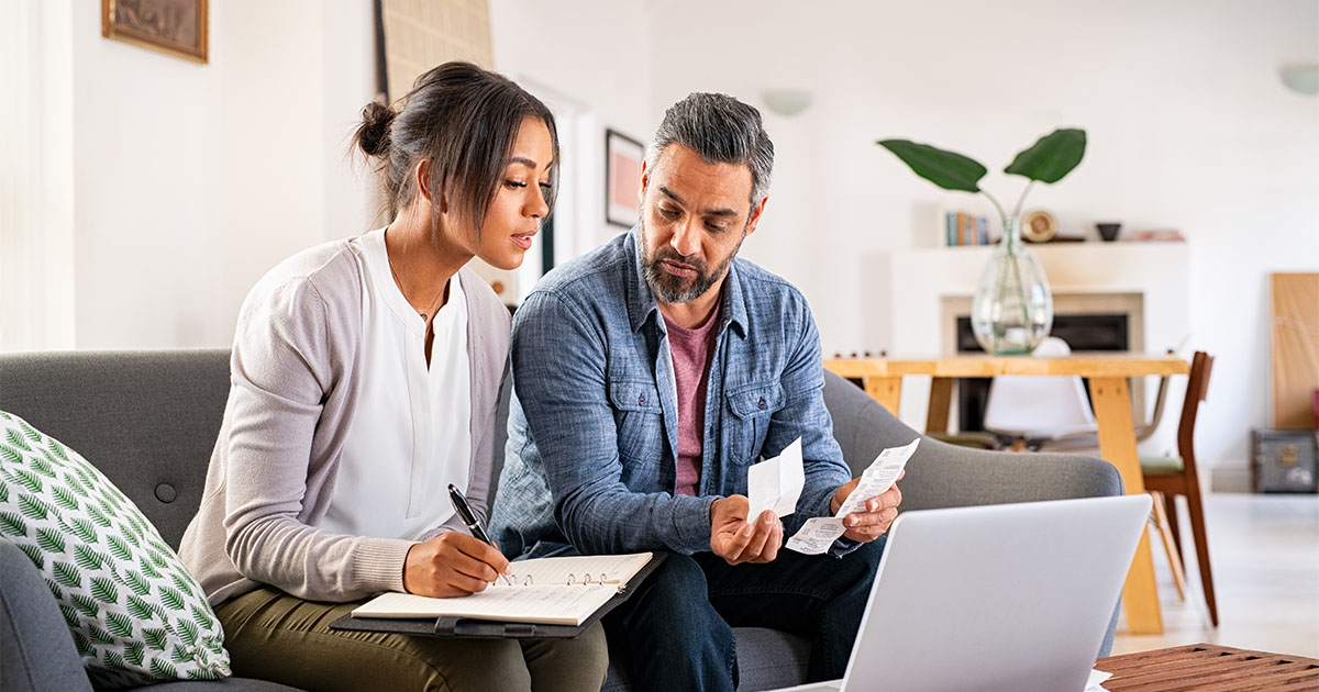 man woman on couch looking at computer