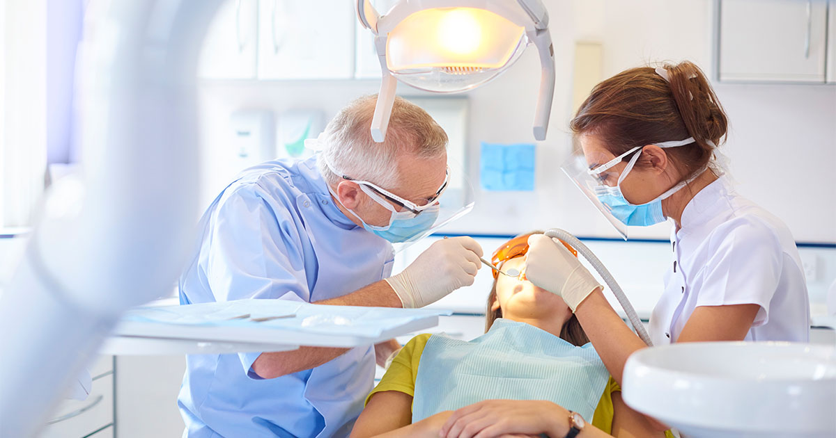 dentist working on patient dentalcorp
