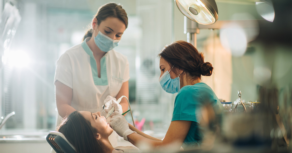 dental nurses operating on patient