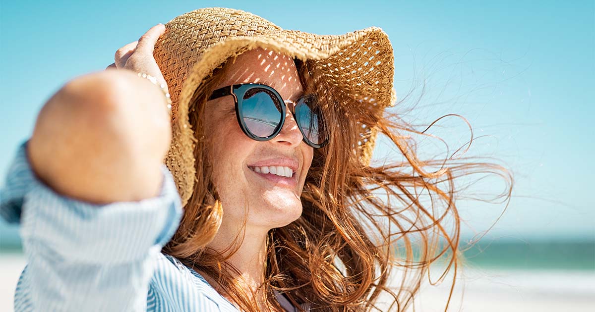 woman wearing sunglasses and hat