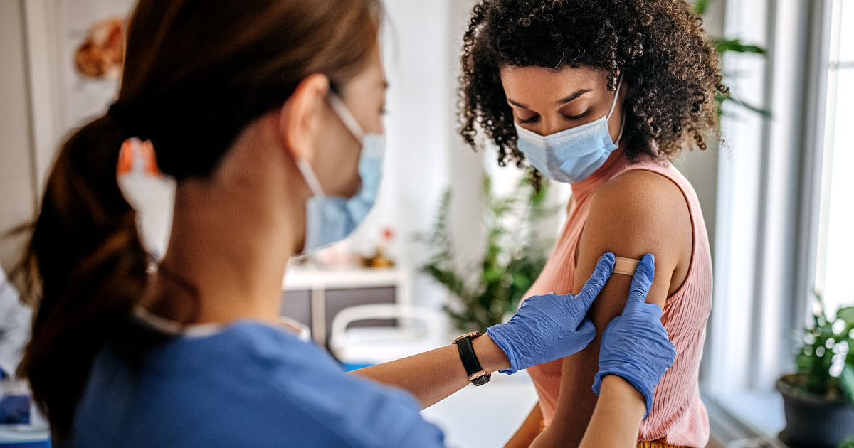 Nurse attending to black woman