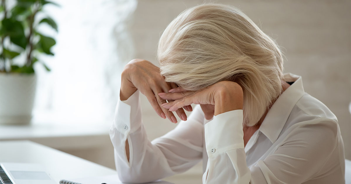 A picture of an elderly lady looking stressed
