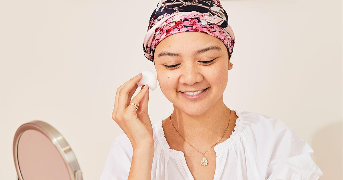 A picture of a woman applying makeup_Look good feel better