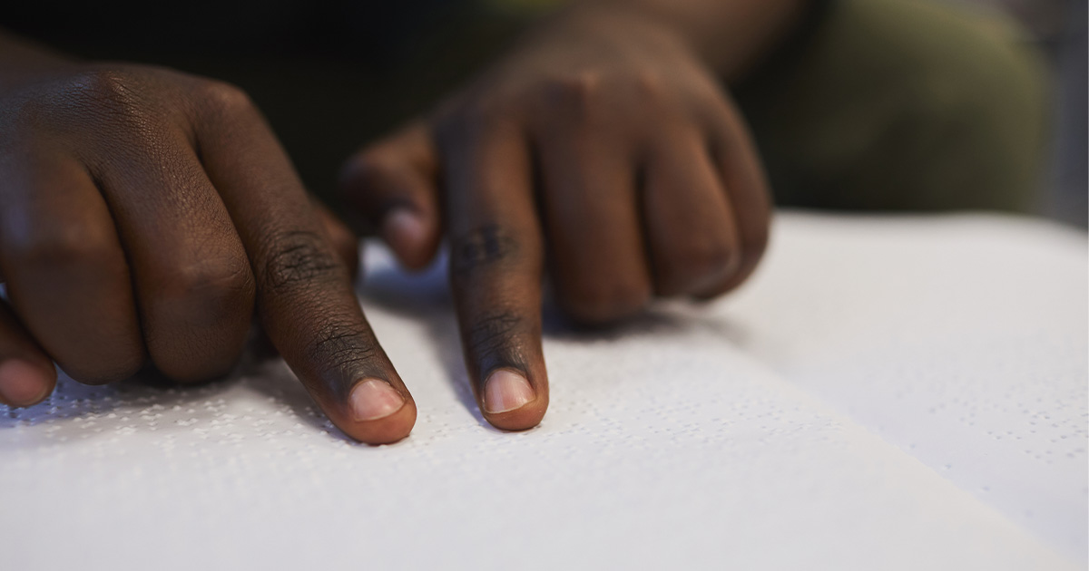 A close up of a child reading braille