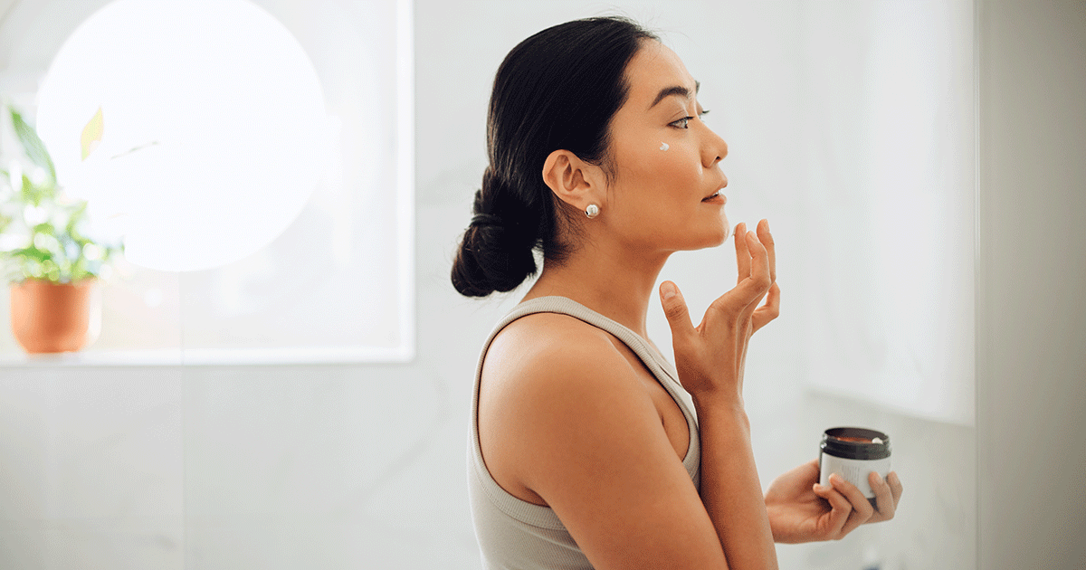 Woman Applying Face Cream in her Home