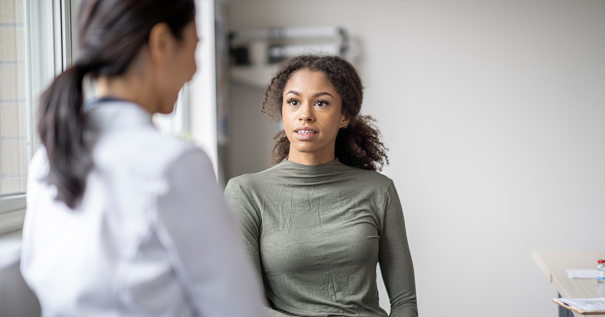young woman talking with doctor