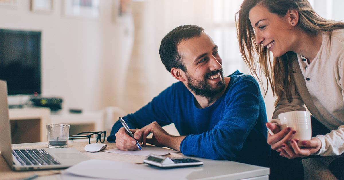 Couple doing digital banking and smiling