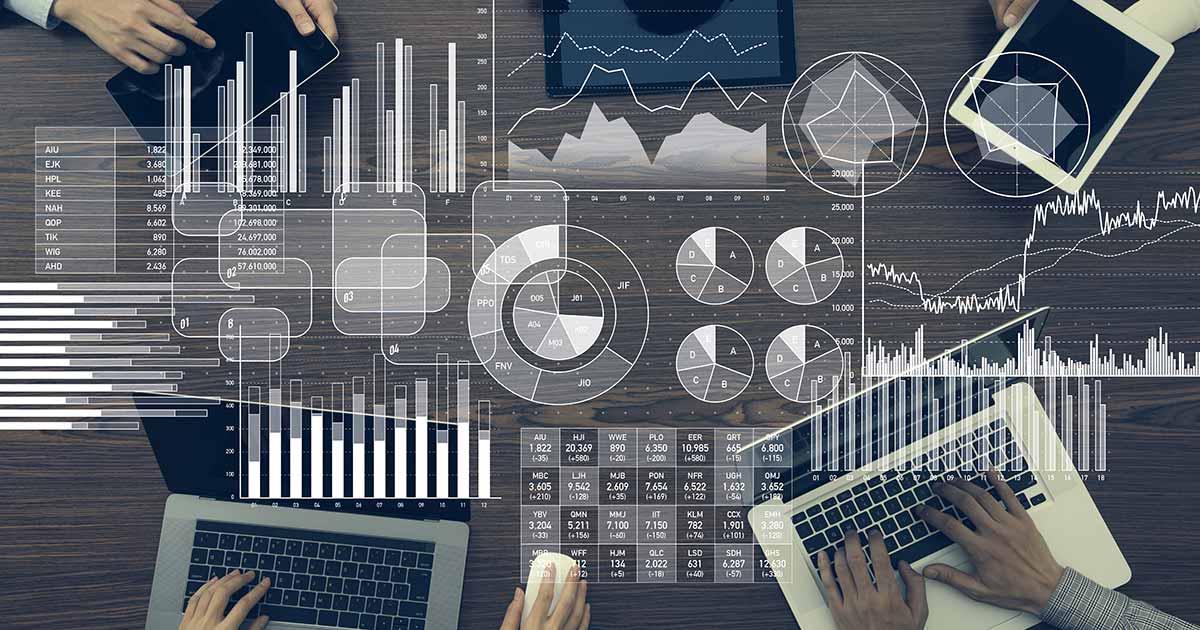 Charts and graphs shown on top of people working on laptops