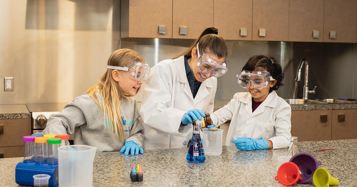 Three girls enjoying a science experiment