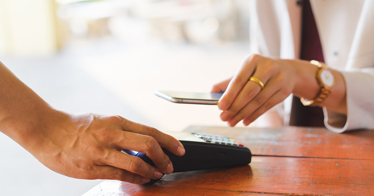 Customer paying for service with their mobile phone