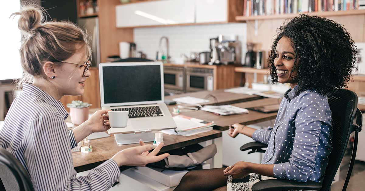 Two women sharing ideas in an office