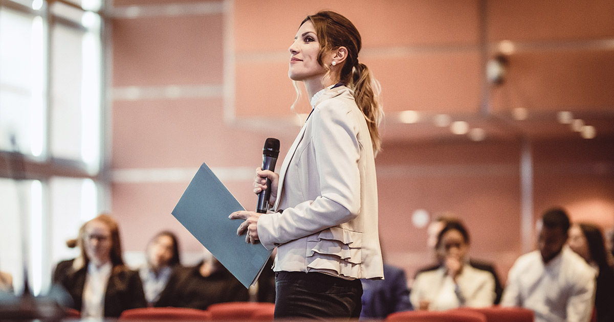 A woman leading a conference