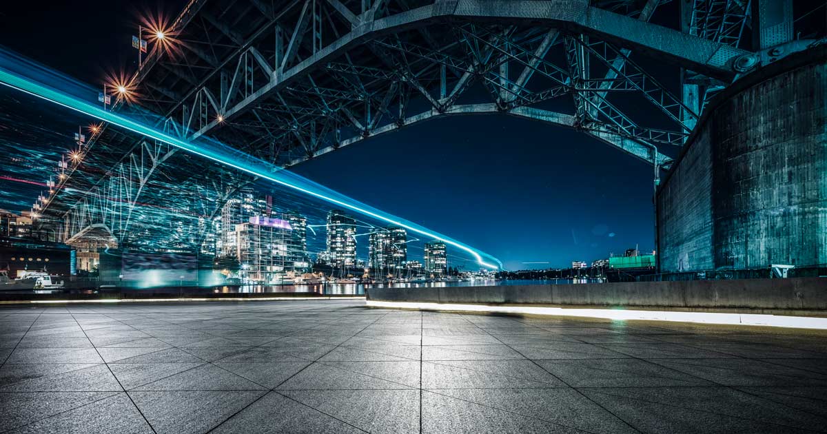 Long exposure of lights under a bridge at night