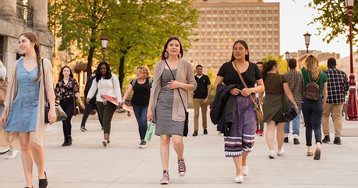 Two Indigenous students walking along the uOttawa campus
