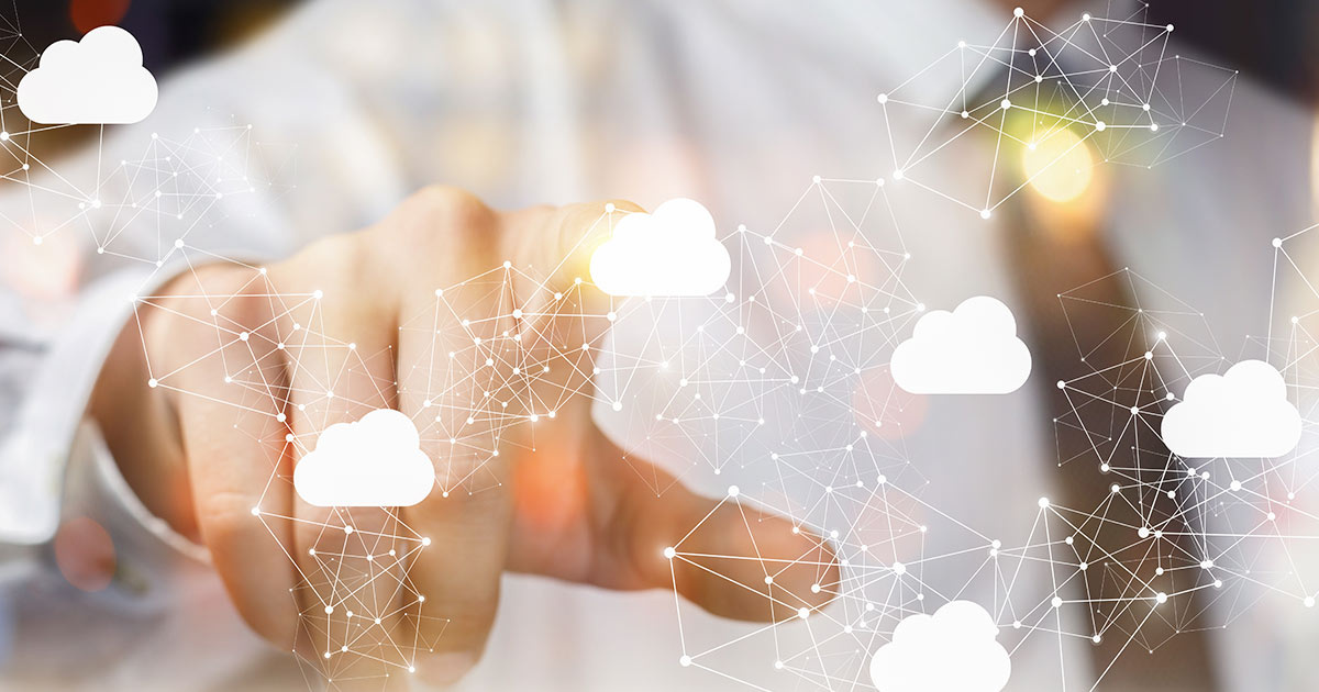 Person in suit pointing at image of a hybrid cloud