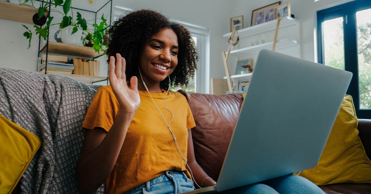 Young Black woman waving on a video call