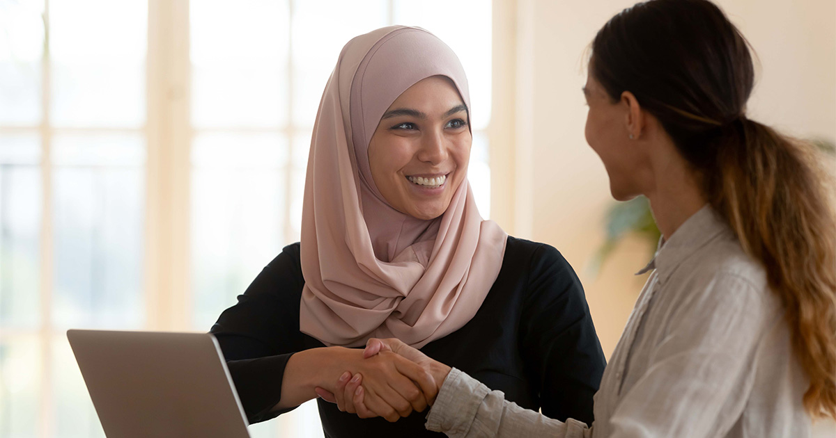 muslim woman shaking hands