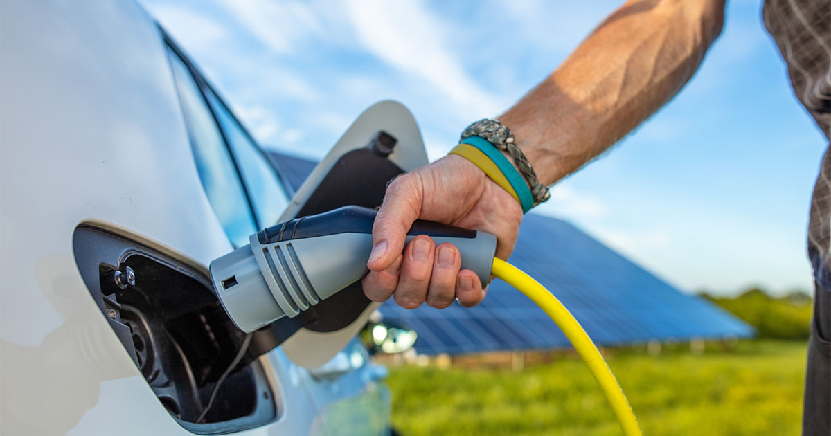 man charging EV