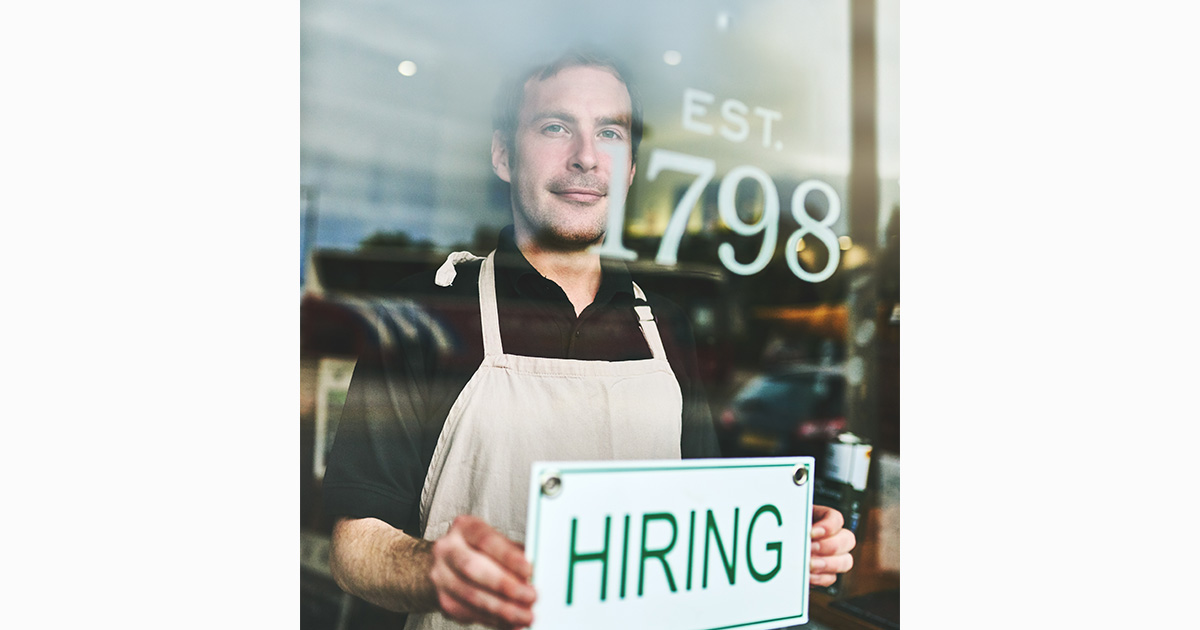 man holding for hire board
