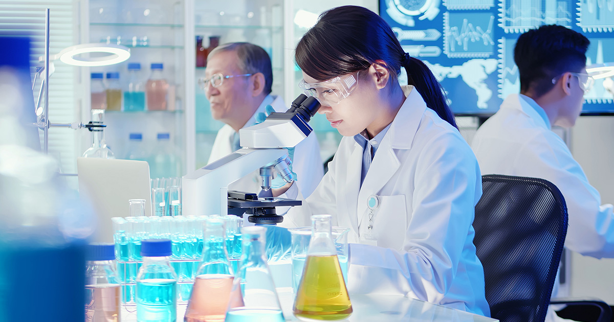 woman researcher in white lab coat and glasses
