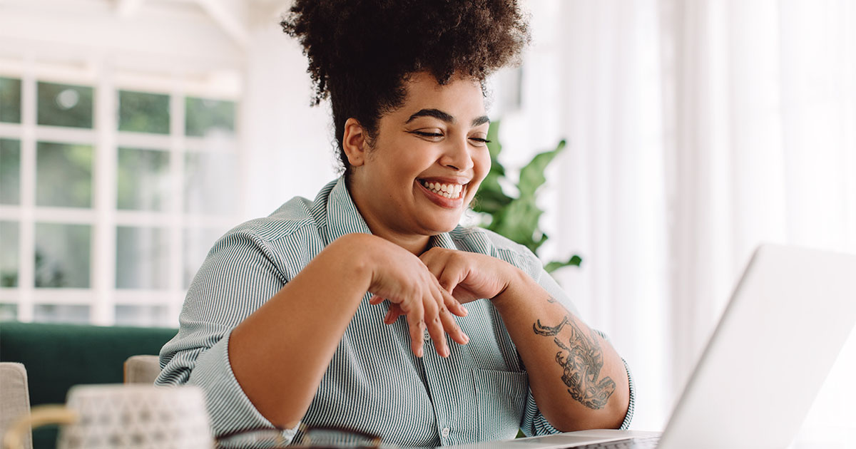 african american woman smiling looking at computer