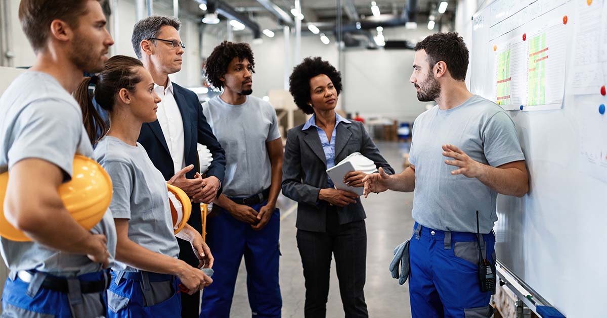 young worker giving presentation in front of whiteboard