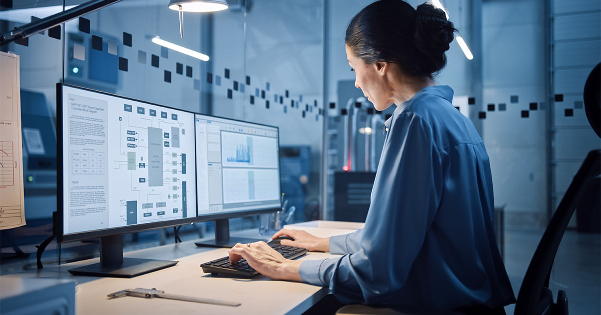 woman working on computer in dark room