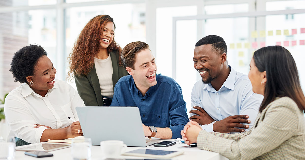 office workers of different races laughing