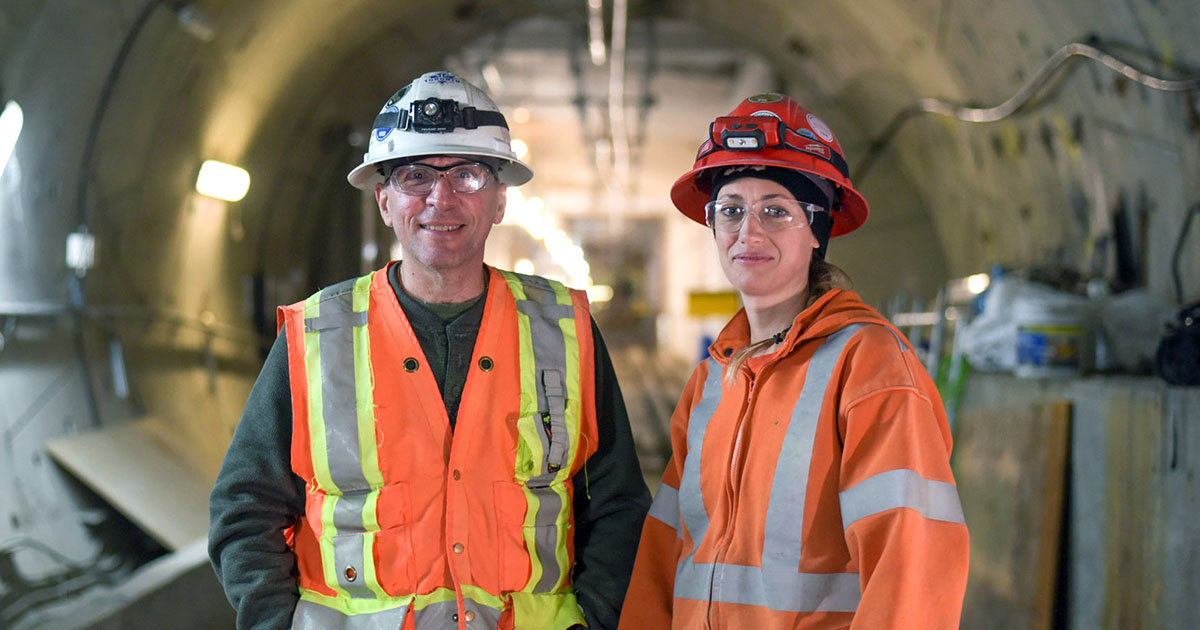 man and woman wearing safety vests and protective gear