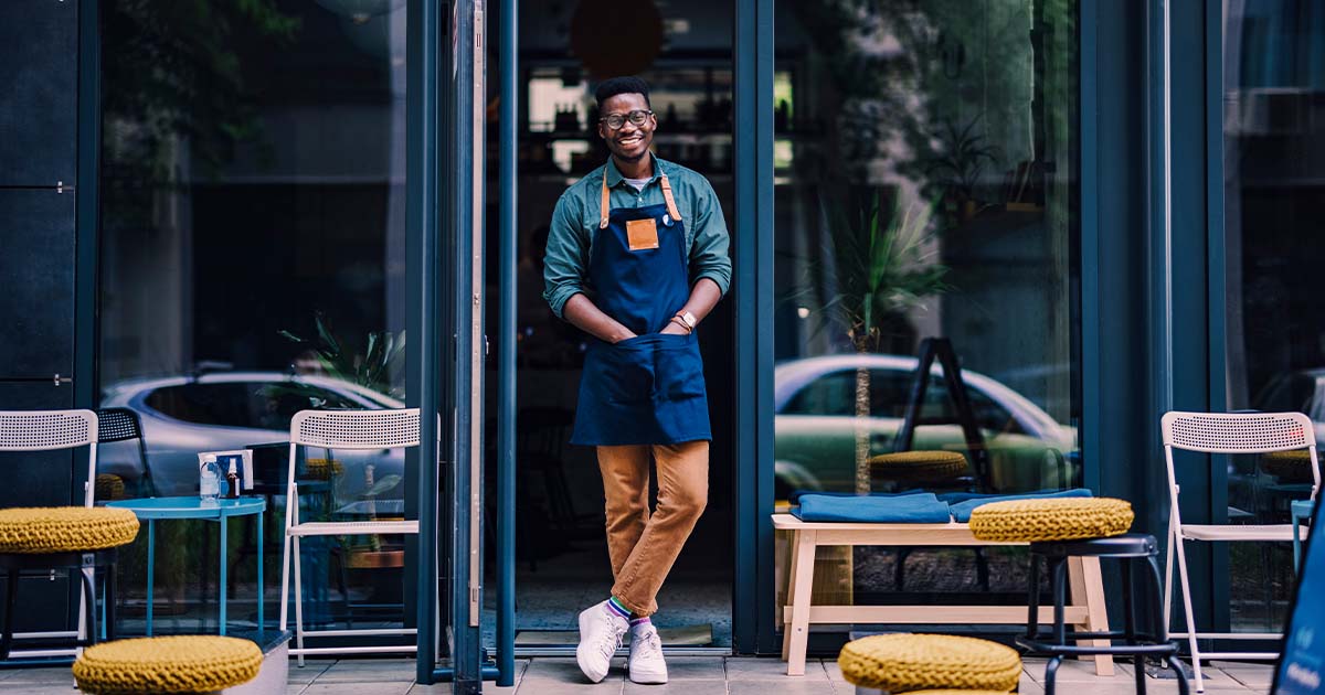 restaurant owner standing in door