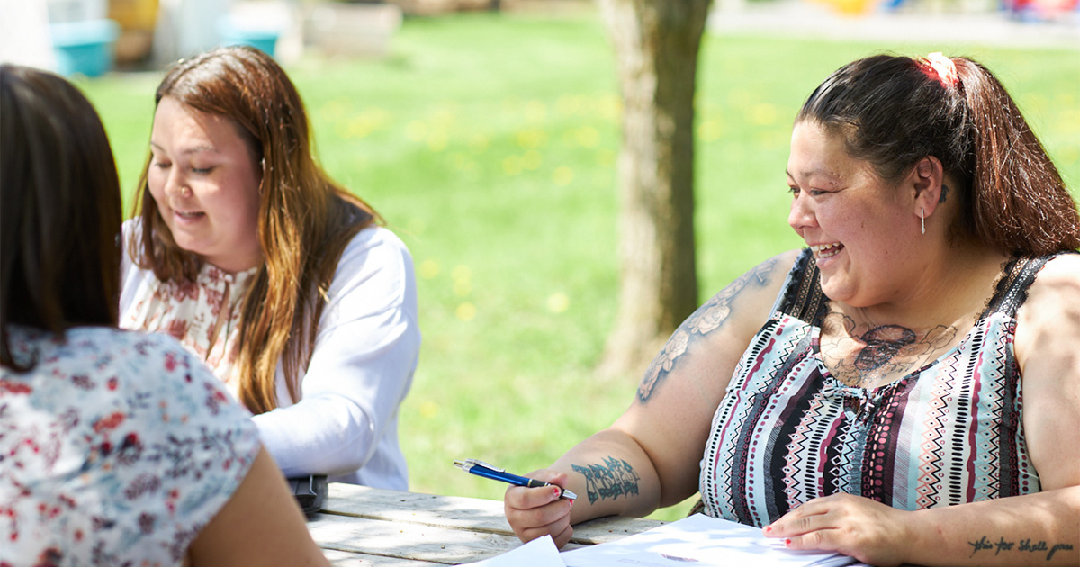indigenous women sitting at table