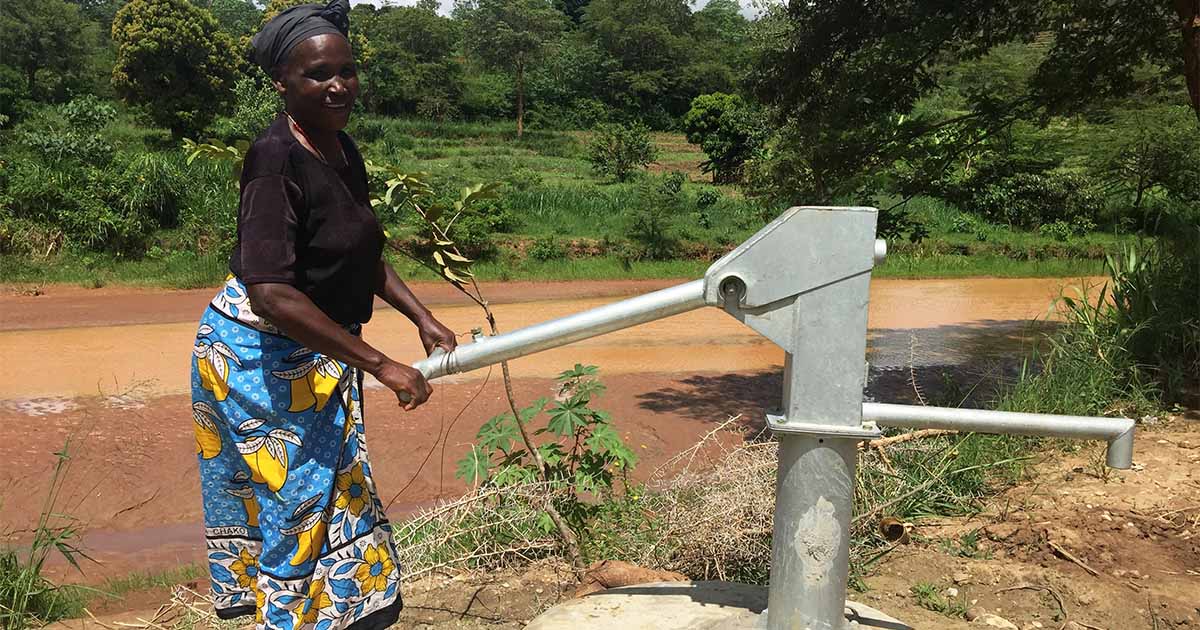 Woman making use of a water well