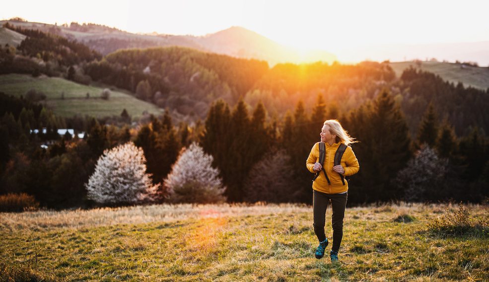 Front,View,Of,Senior,Woman,Hiker,Walking,Outdoors,In,Nature