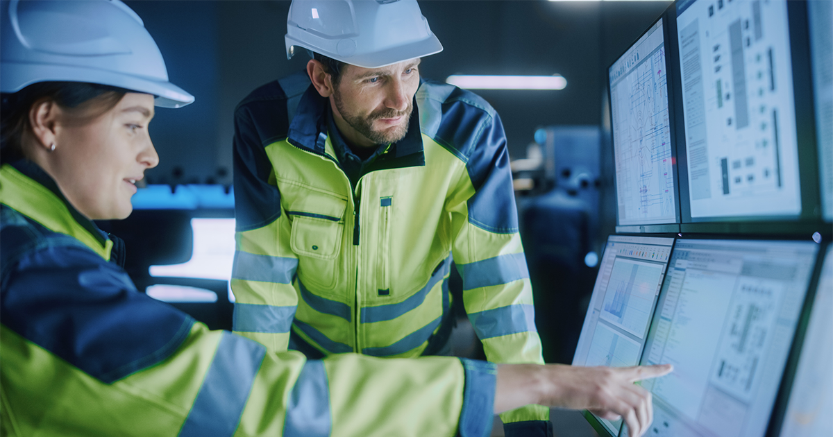 Project Engineer Talks to Female Operator who Controls Facility Production Line