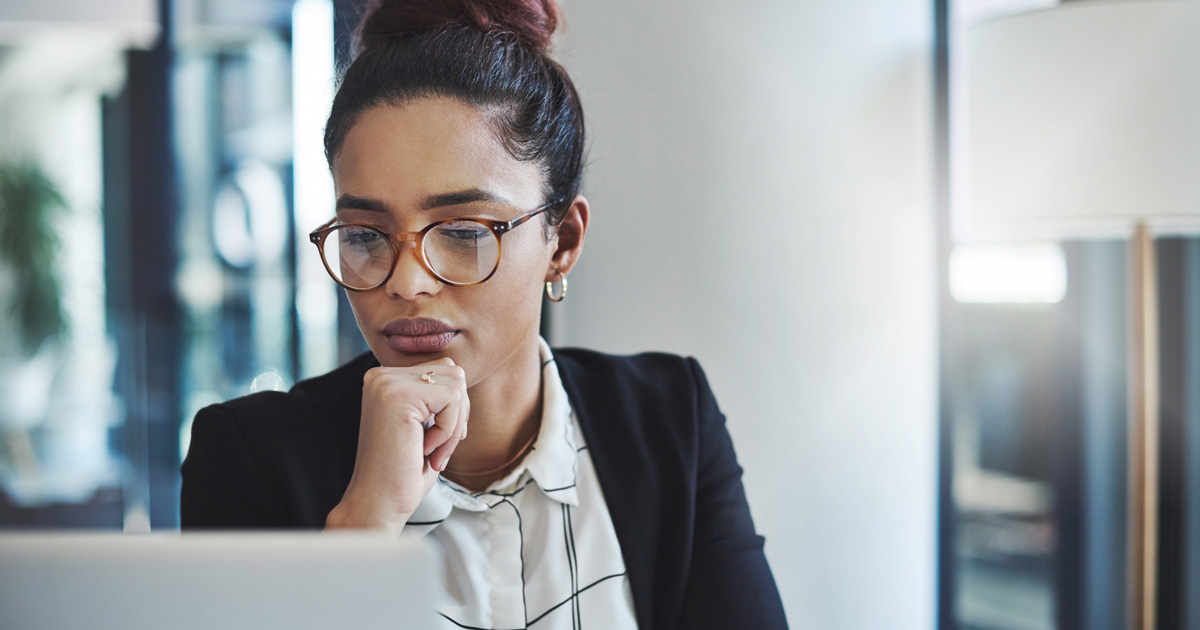 Shot of a young businesswoman using a laptop in a modern office
