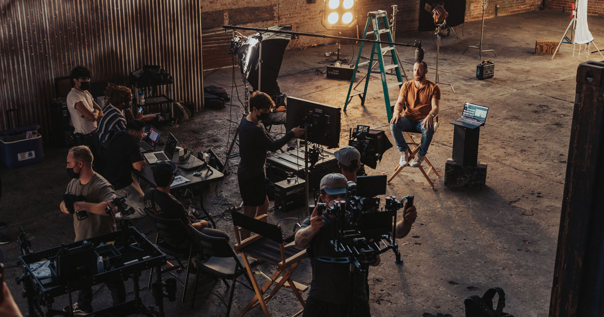 A film set and crew preparing for a shoot in a warehouse